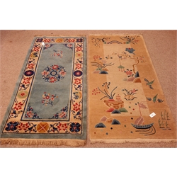  Chinese style beige ground rug depicting rural scenes (181cm x 93cm) and a Chinese style blue ground rug with floral field (177cm x 94cm)  
