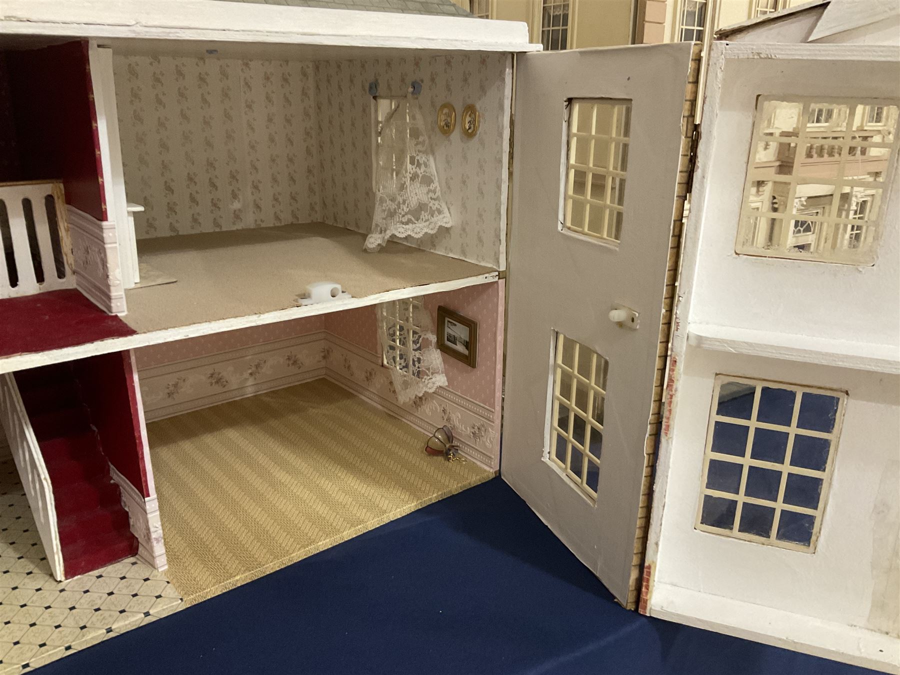 Modern scratch-built Palladian style wooden dolls  house as a 19th century double fronted two-storey property with simulated brick and stone walls under a removable simulated slate hipped roof; the triple hinged front elevation opening to reveal six rooms with central hall, stairs and landing L94cm H56cm D40cm