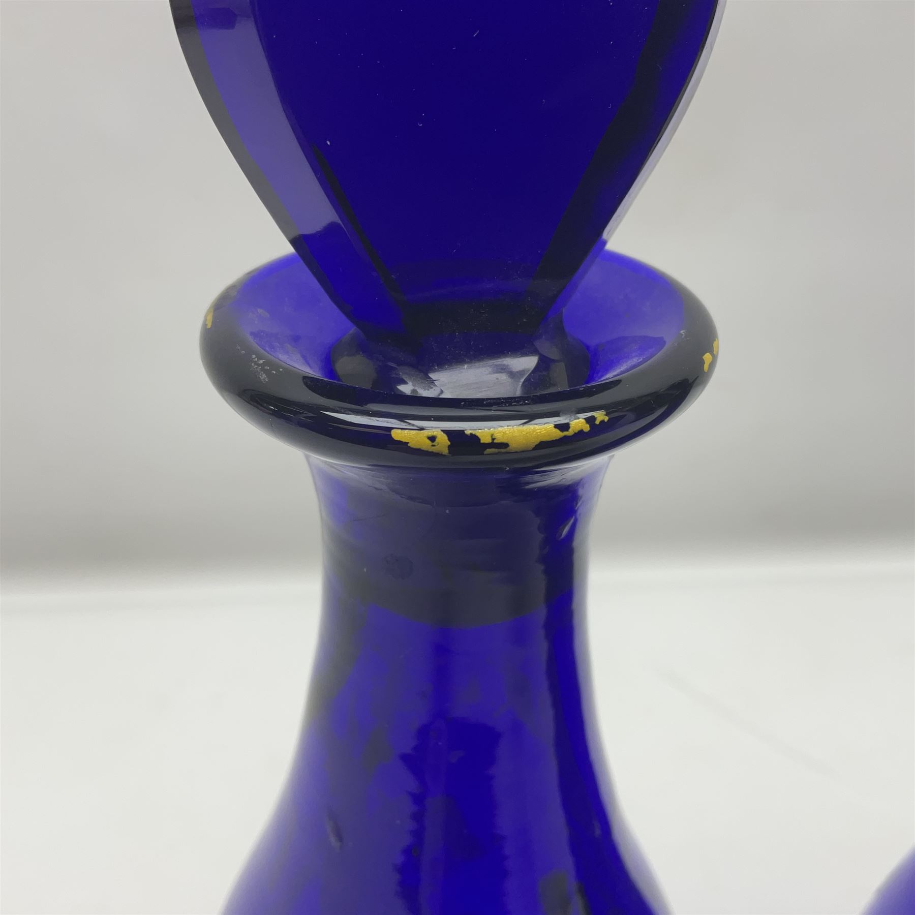 Pair of early 19th century blue glass decanters with teardrop stoppers, with gilt writing, the first marked Gin the second Brandy 