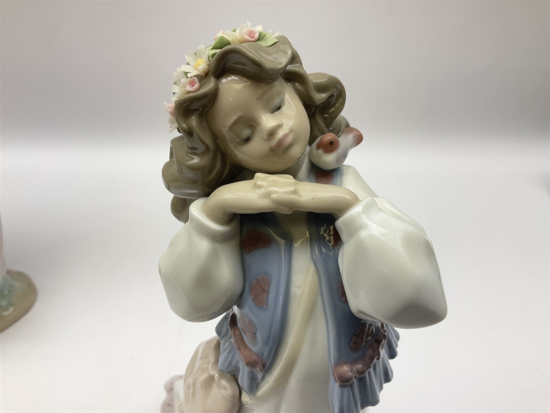 Three Lladro figures, comprising, Dreams of Summer Past no 6401, Spring Breeze no 4936 and Breezy Afternoon 5682 together with Lladro plaque Art Brings us Together no 7677, all in original boxes, largest example H35cm