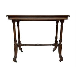  Late Victorian rosewood stretcher table, the rectangular top with curved canted cornice and moulded edge, on quadruple turned pillar supports carved with foliage, joined by collar turned stretcher, on splayed moulded supports with brass and ceramic castors