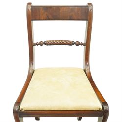 Late 20th century Regency style mahogany dining chairs, set of four, bar backs with figured veneered top rails and turned spindle stretchers, drop-in seats upholstered in beige leather, on moulded sabre supports