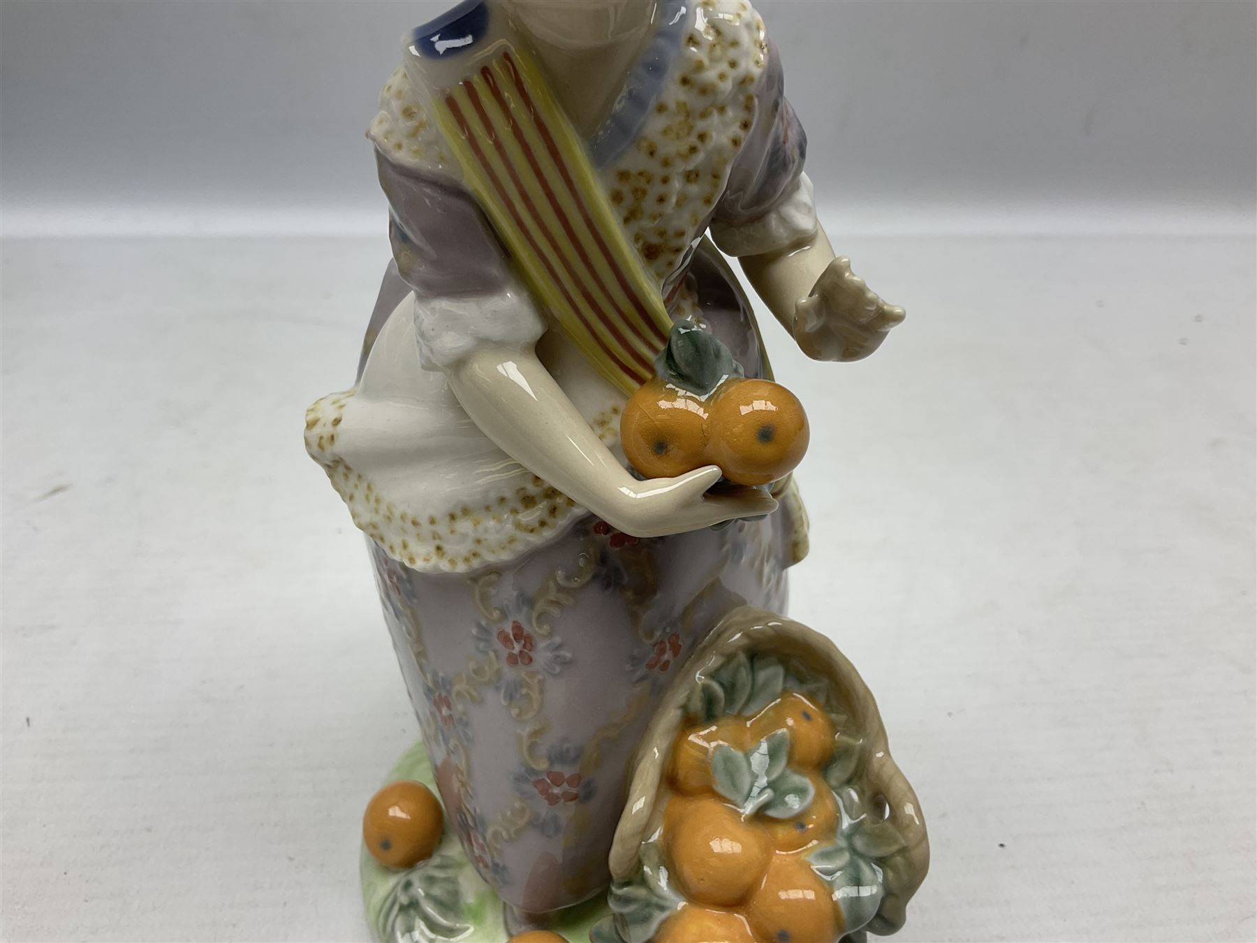 Lladro figure, Miss Valencia, modelled in traditional Valencian dress with basket of oranges, sculpted by Juan Huerta, with original box, no 1422, year issued 1982, year retired 1997, H18cm