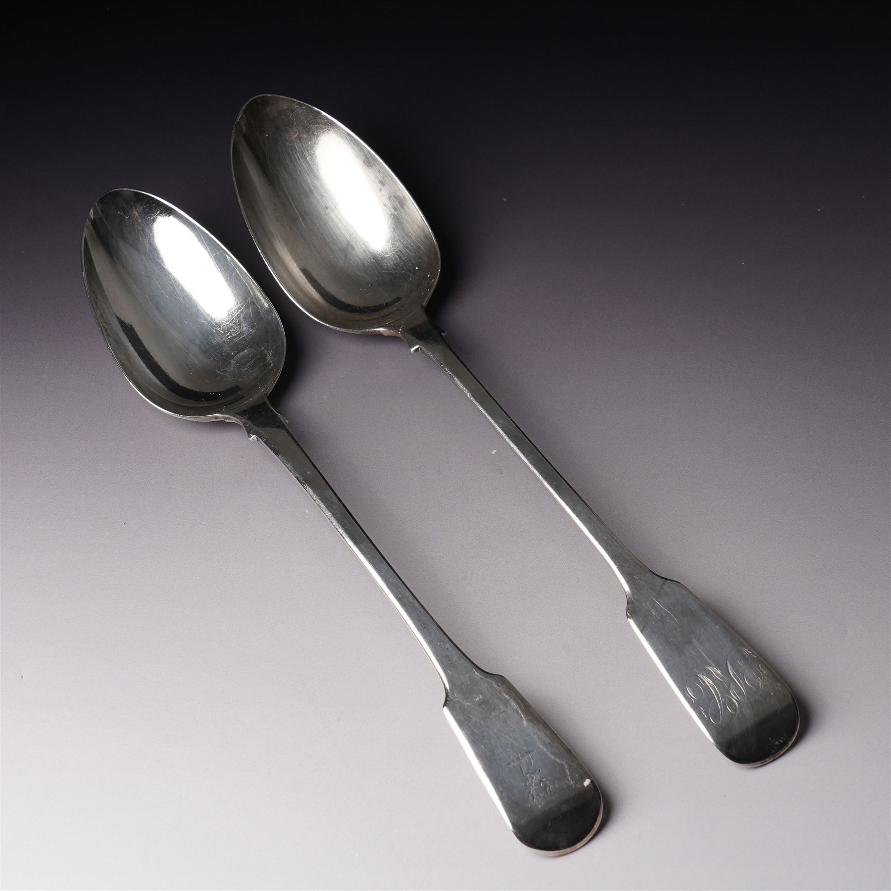  George IV silver fiddle pattern basting spoon engraved with monogram London 1827 Maker Clement Cheese and another London 1823 Maker George Turner (2)
