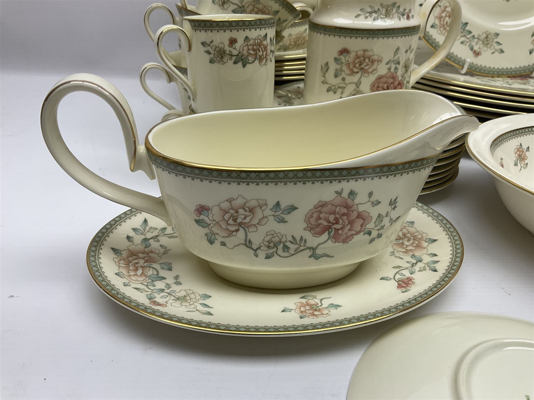 Minton Jasmine pattern tea and dinner wares, including dinner plates, sauce boats, side plates, bowls, teacups, coffee cans and twin handled soup bowls, etc (122)