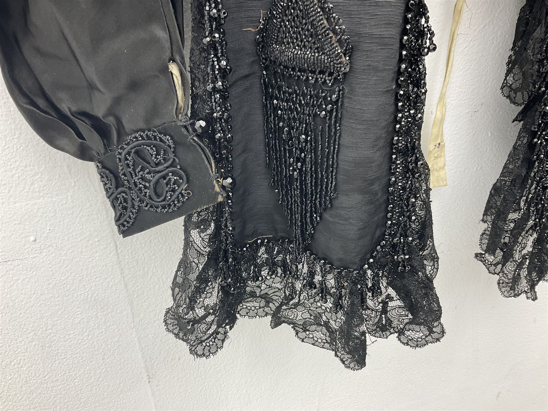 Victorian three piece mourning dress, with lace trim and jet beading, including velvet coat with satin collar panels and cuffs, the nipped waist with boning and slight flared peplum, heavily embellished beaded high neck collar, and ladies embroidered silk lined purse with gilt handle, mount and clasp