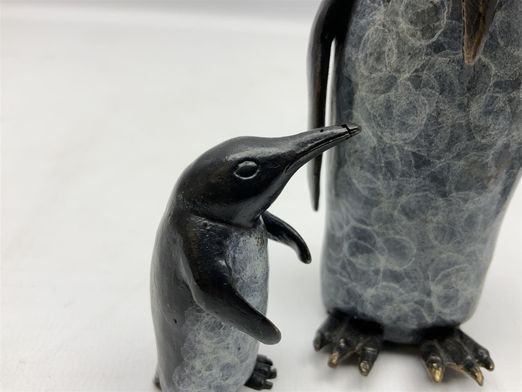 Steve Boss (British 1970-); Bronze figure group of a family of Emperor penguins, entitled Waddle, all with artists monogram beneath, tallest H12cm
