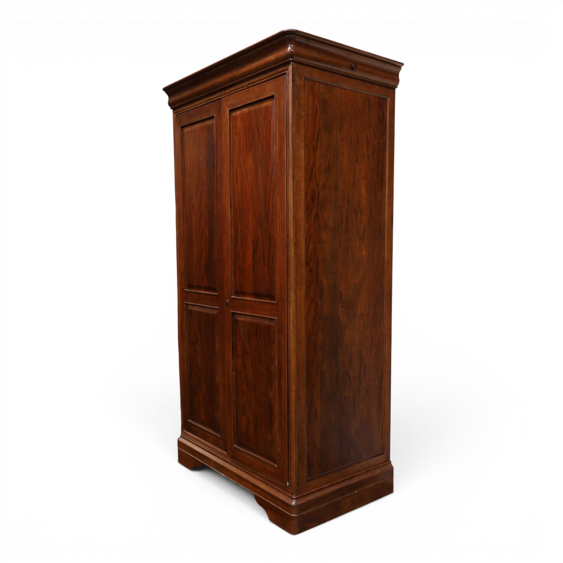 Willis & Gambier - mahogany bedroom wardrobe, projecting cornice with two additional rails, panelled doors with trouser rack and blue baize trinket, enclosing a shelf above a wooden clothes rail and shoe rack, raised on bracket feet 