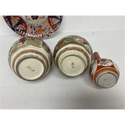 Collection of Japanese ceramics comprising pair of Satsuma vases decorated with panels depicting children and samurai figures, together with a Kutani vase painted with birds and flowers, all with painted character marks beneath, and an Imari plate, largest vase H31cm