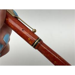 Vintage Swan Mabie Todd lever fill fountain pen in coral red, the nib a/f marked 14K, together with two further vintage Swan Mabie Todd fountain pens, the first example with lever fill, the other leverless, each with black body, one with nib marked 14ct, (3) 