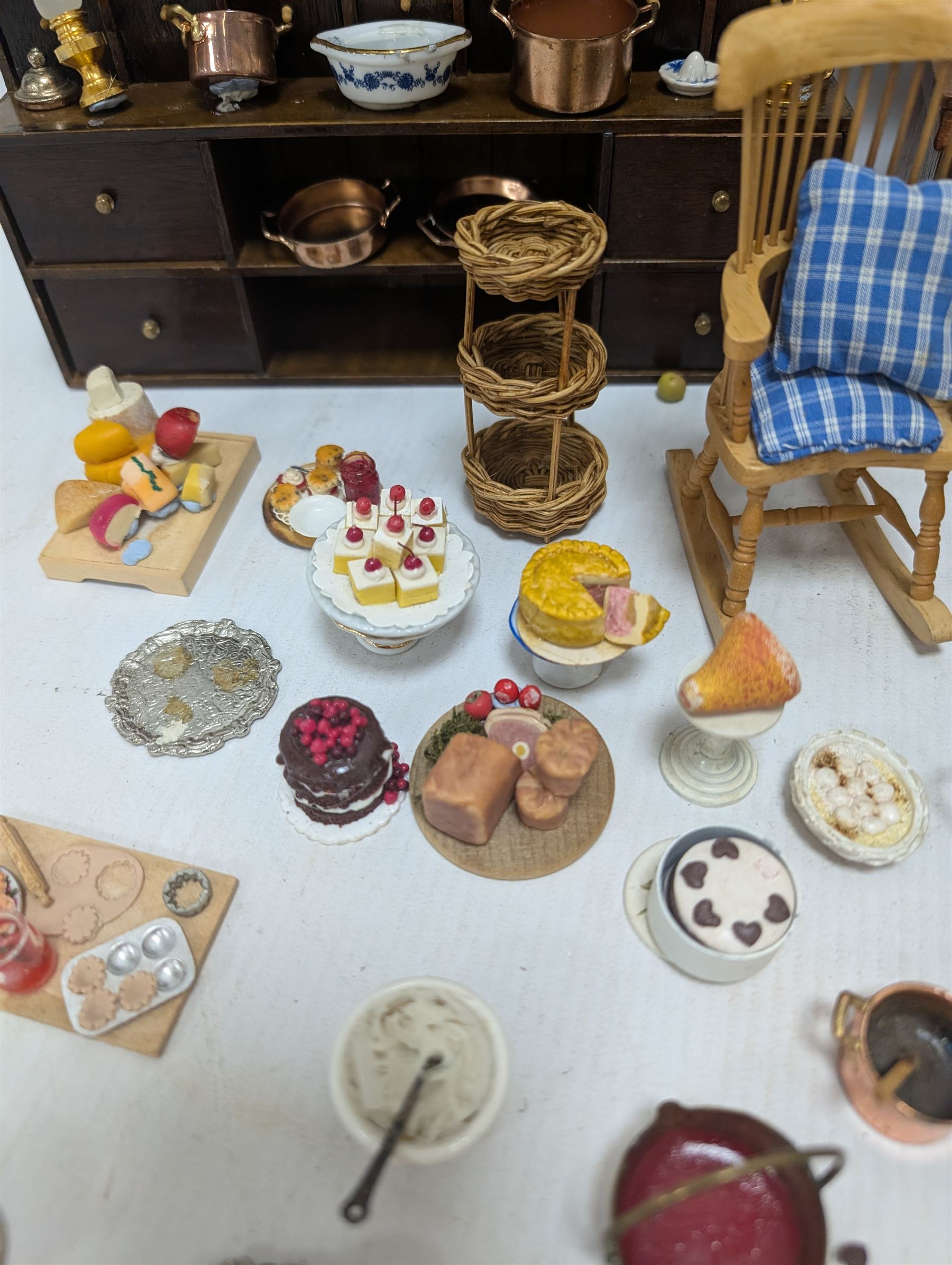 Victorian and later style dolls house kitchen furniture, including countertop, dresser displaying copper pots and blue and white ceramics, baking table, oven, three figures and a collection of food and baking accessories