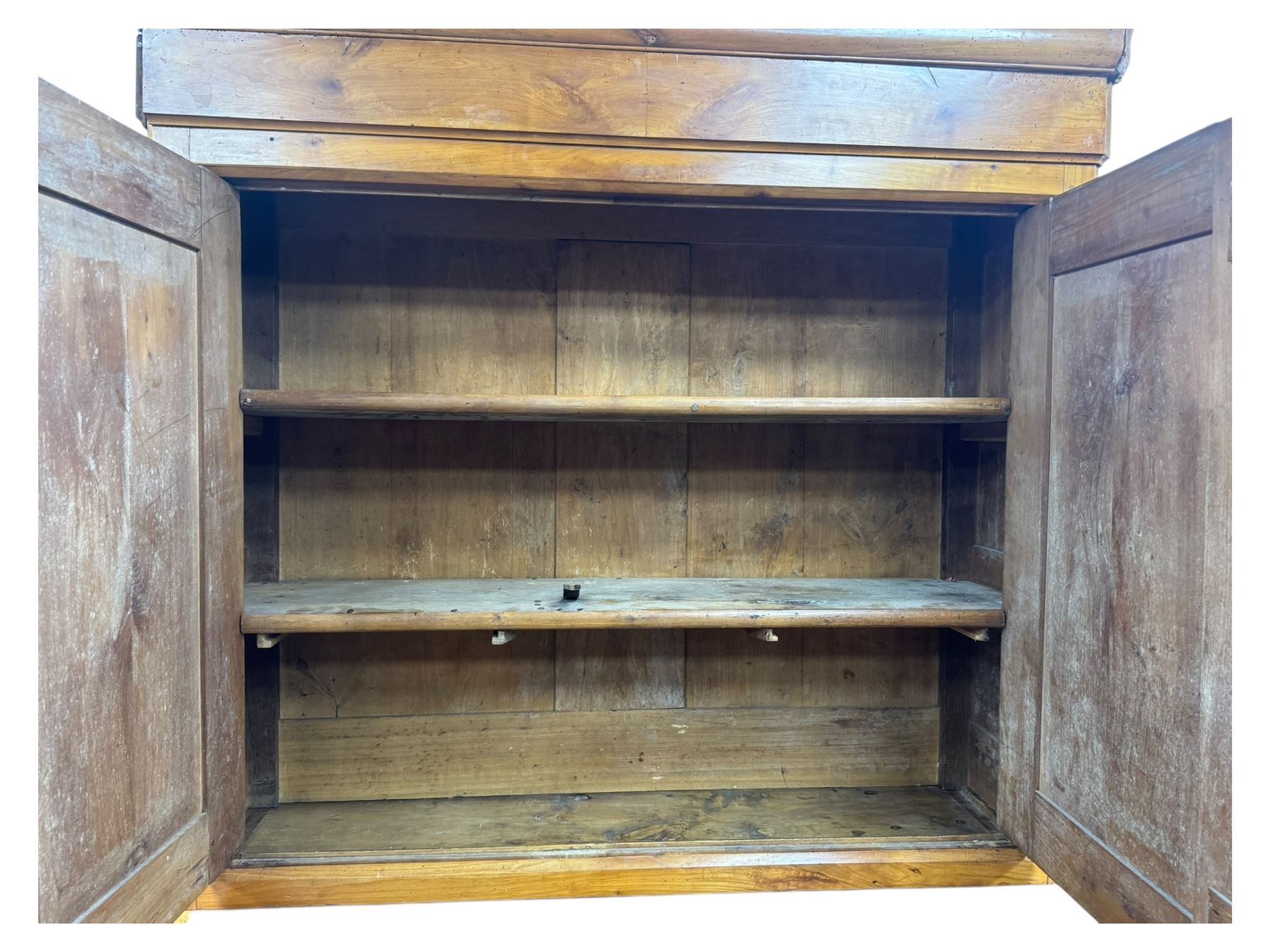 19th century French walnut dresser, the moulded cornice over two-panelled cupboard doors, enclosing two shelves and one small
drawer, on a base of two further cupboards