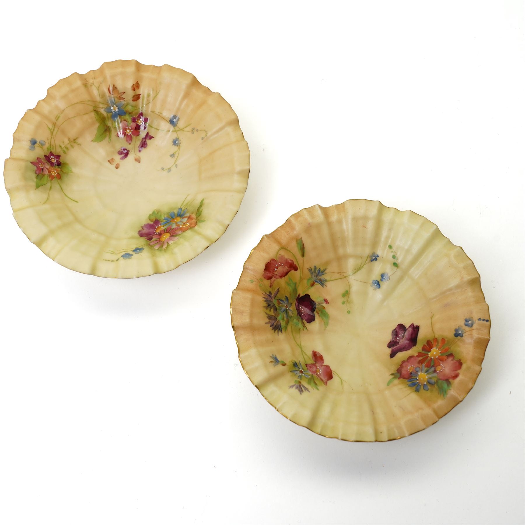 Pair of Royal Worcester blush ivory figures from the Countries of the World series 'Irish Girl' 1874 and 'Welsh Girl' 1875, pair of Royal Worcester blush ivory shallow shell dishes painted with flowers D12cm and a small Hadley's Worcester cauldron shape vase (5) 