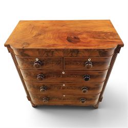 Victorian mahogany bow fronted chest, fitted with two short and three long drawers, flame mahogany front, bone escutcheons and turned wooden handles, quarter barley twist columns, raised on turned supports