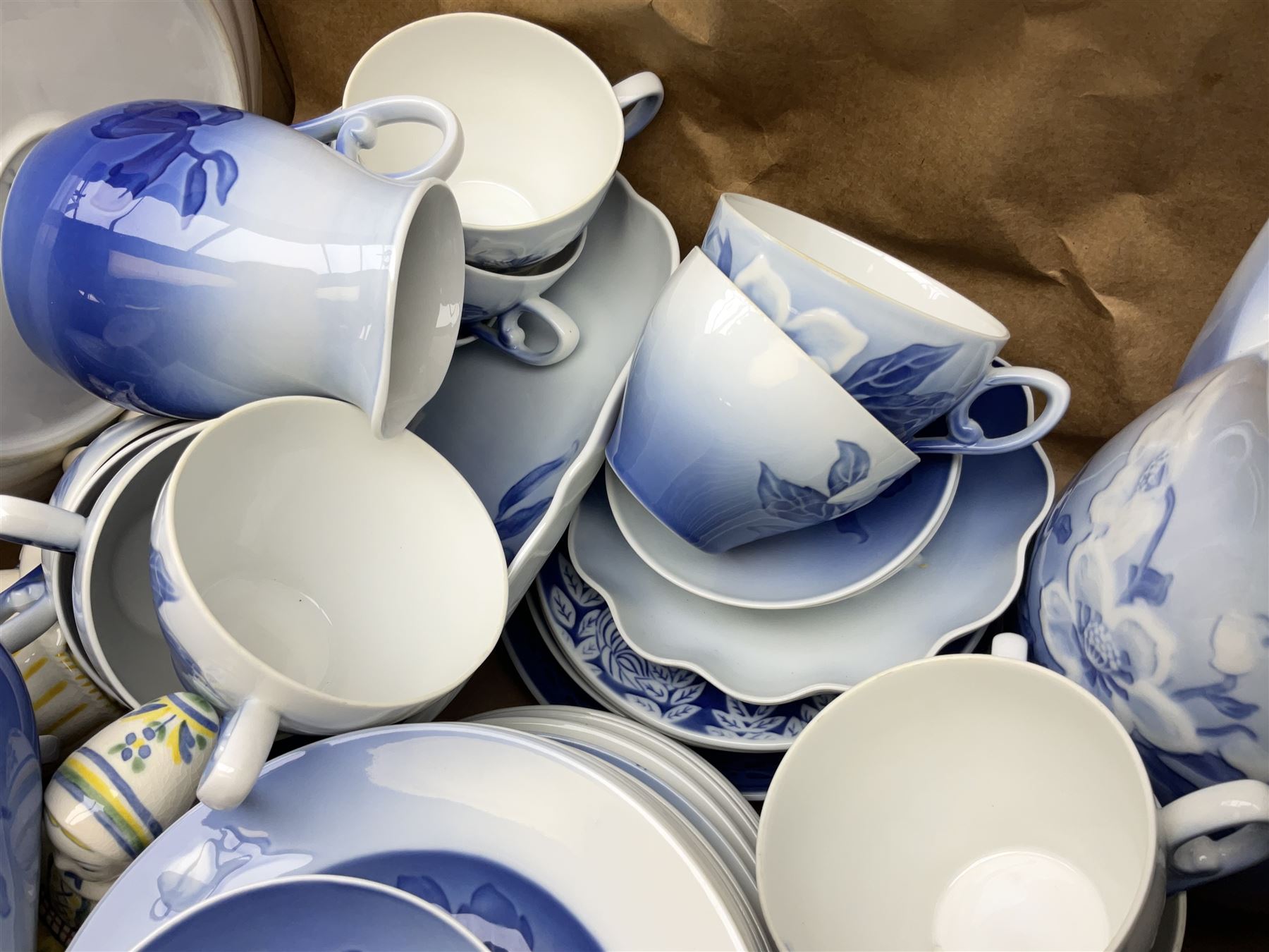  Bing & Grondahl, Copenhagen blue and white Christmas Rose pattern tea wares, to include teapot, covered sucrier, milk jug, fourteen cups and seventeen saucers, etc, together with two Royal Copenhagen collectors plates etc  