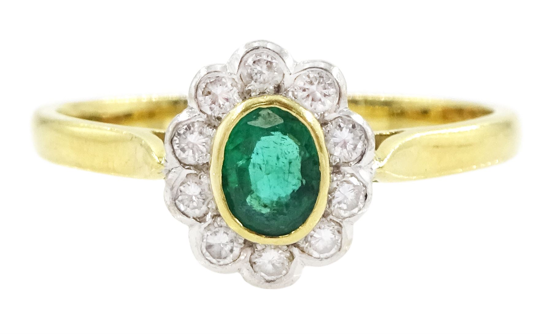 18ct gold emerald and diamond cluster ring, single oval cut emerald of approx 0.25 carat, surrounded by ten round brilliant cut diamonds, Birmingham 1995, total diamond weight approx 0.10 carat