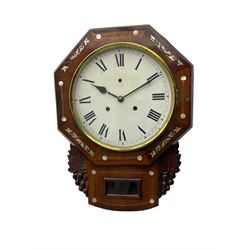 American - late 19th century 8-day mahogany drop dial wall clock, with a hexagonal dial bezel inlaid with mother of pearl, pendulum box with a rectangular viewing glass flanked by carved representations of grape vines, with a painted dial with roman numerals, minute track and steel spade hands within a spun brass bezel, eight day striking movement striking the hours on a gong.   With pendulum & key.