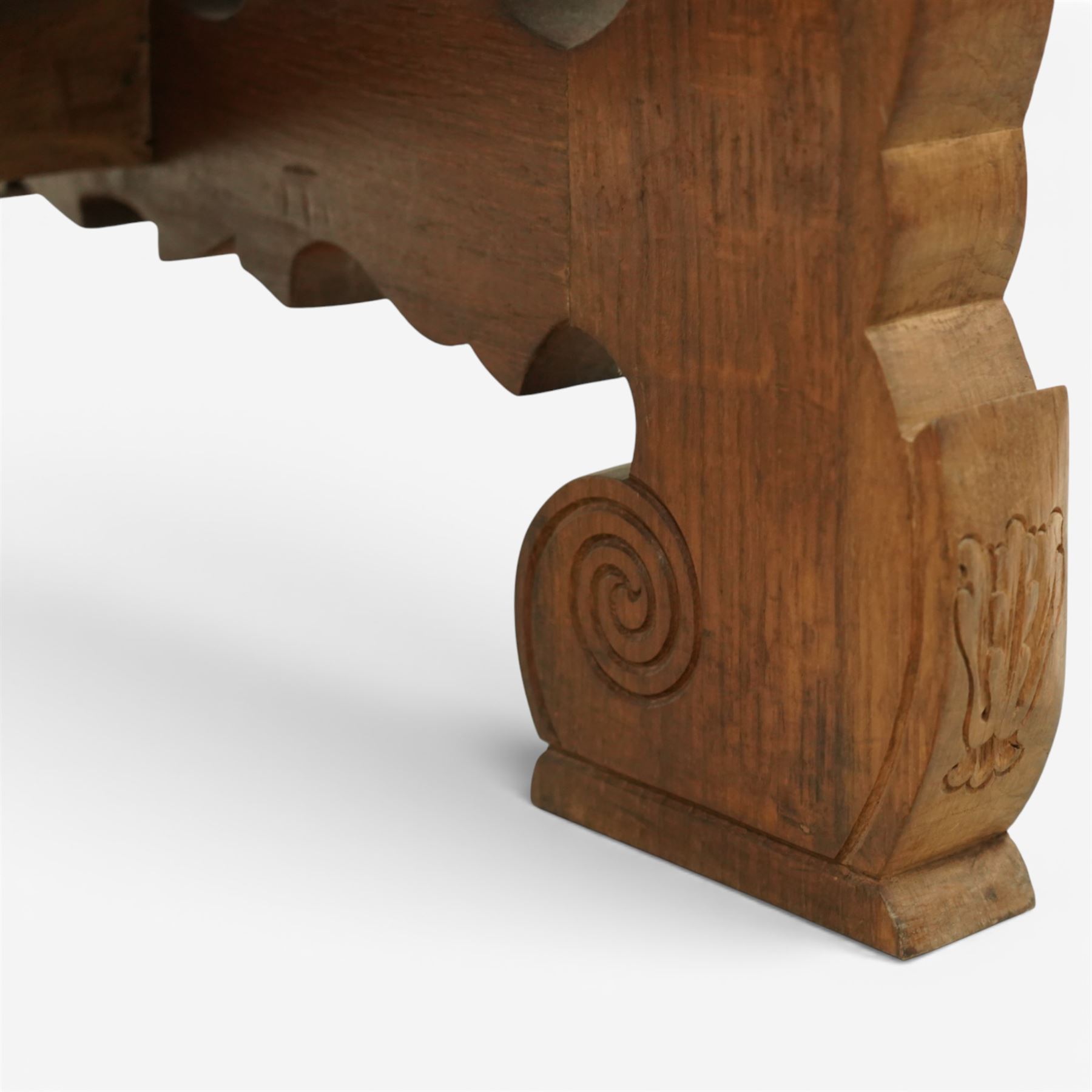 20th century Spanish design oak dining table, large rectangular top above a run of three drawers to the frieze, standing on shaped trestle supports with scroll cut details and stretcher base