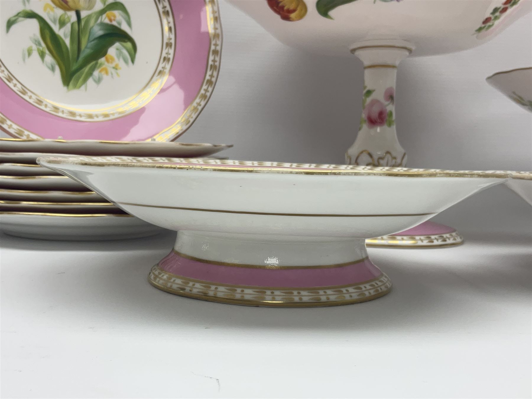 Victorian Copeland, Botanical dessert service, decorated with floral sprigs to the centre with a pink and gilt border, comprising five comports and seven plates, largest comport H20cm, plate D22cm