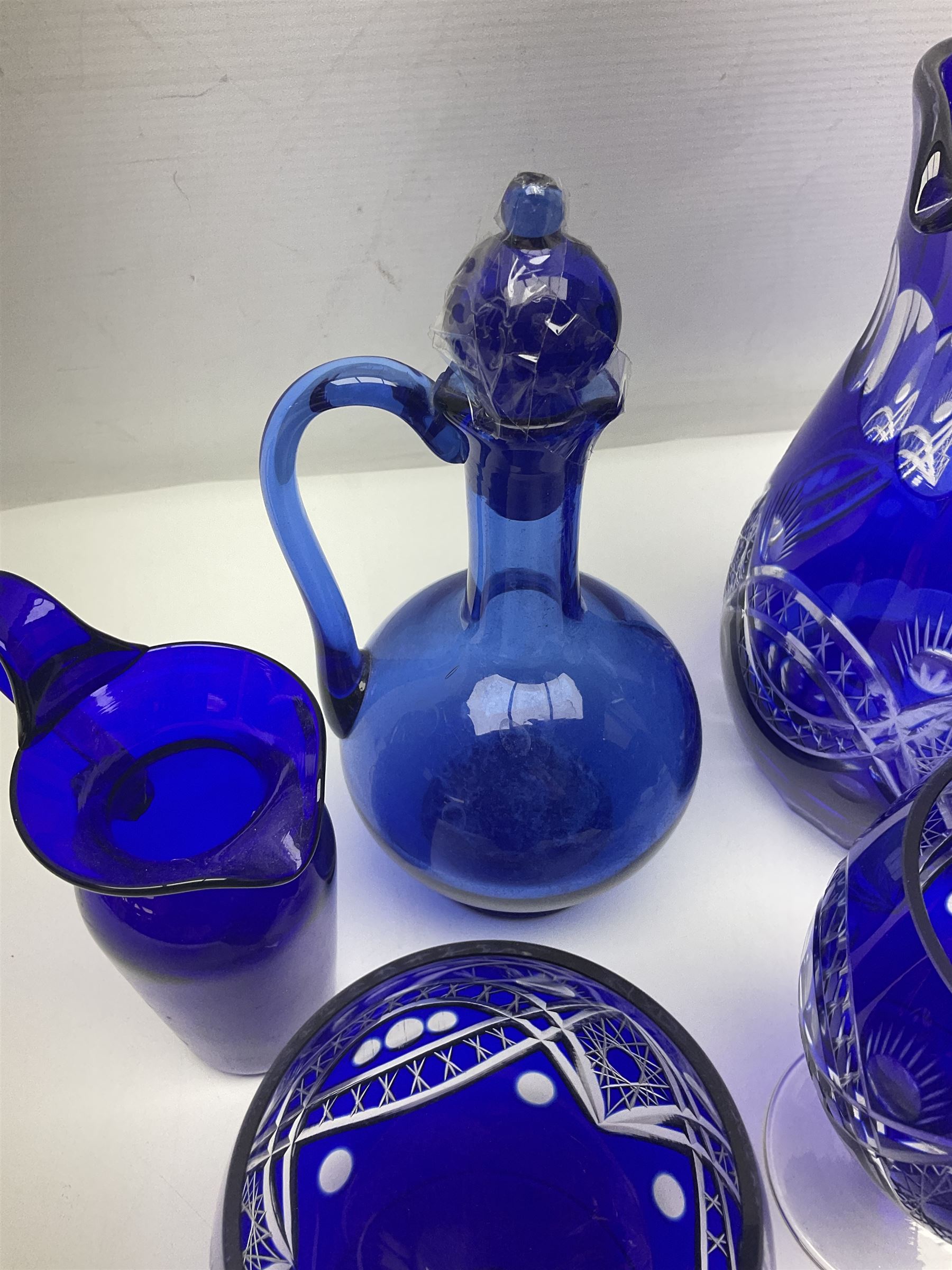 Bristol blue glass jug, together with blue claret jug, saucer, blue cut water jug, and seven matching glasses, water jug H22cm