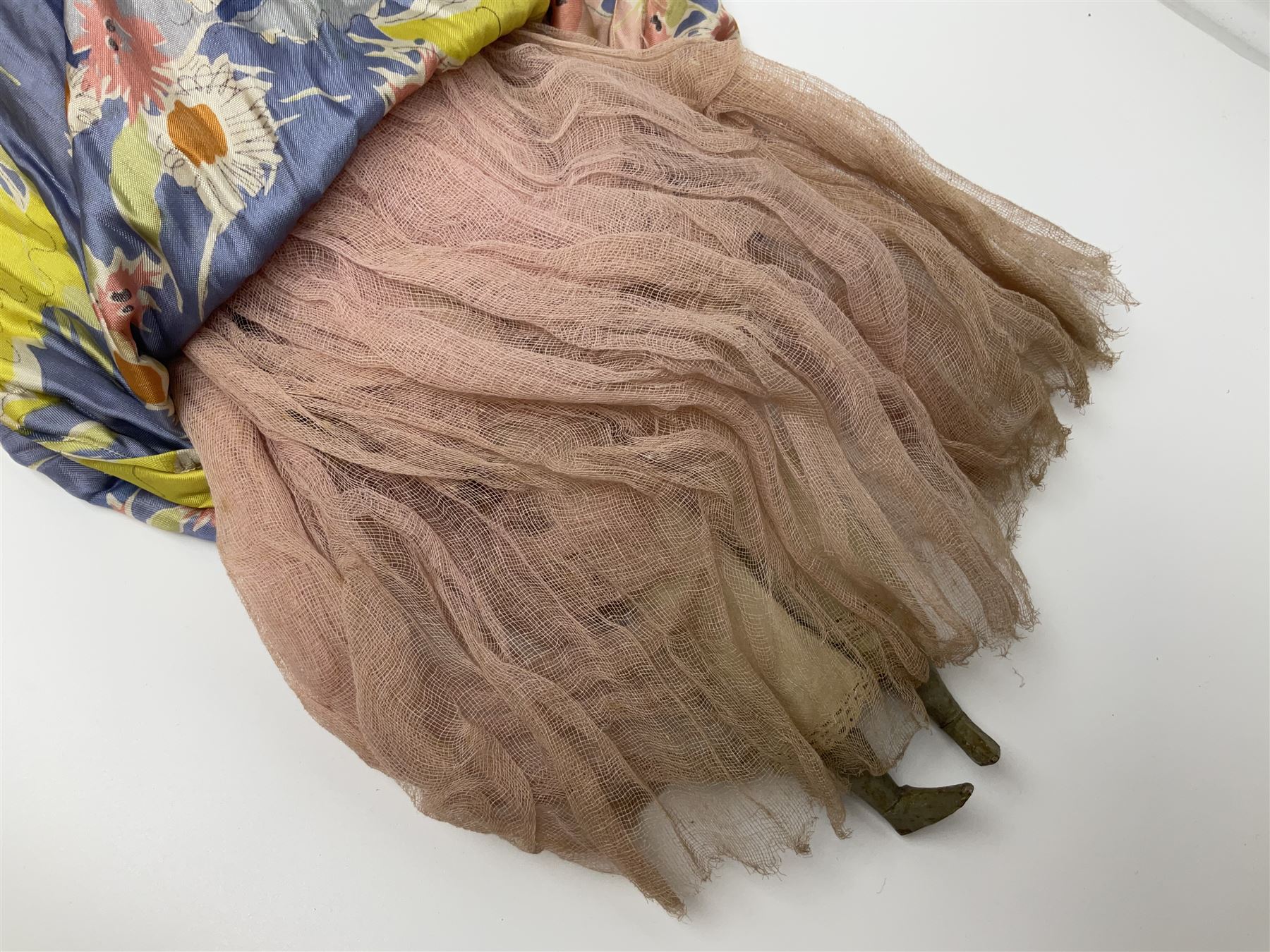 Victorian large wax over composition Pumpkin head doll, with inset dark glass eyes, moulded blonde hair in curls, stuffed body with carved and painted wooden limbs, grey painted boots, floral satin dress with netting underclothes H61cm