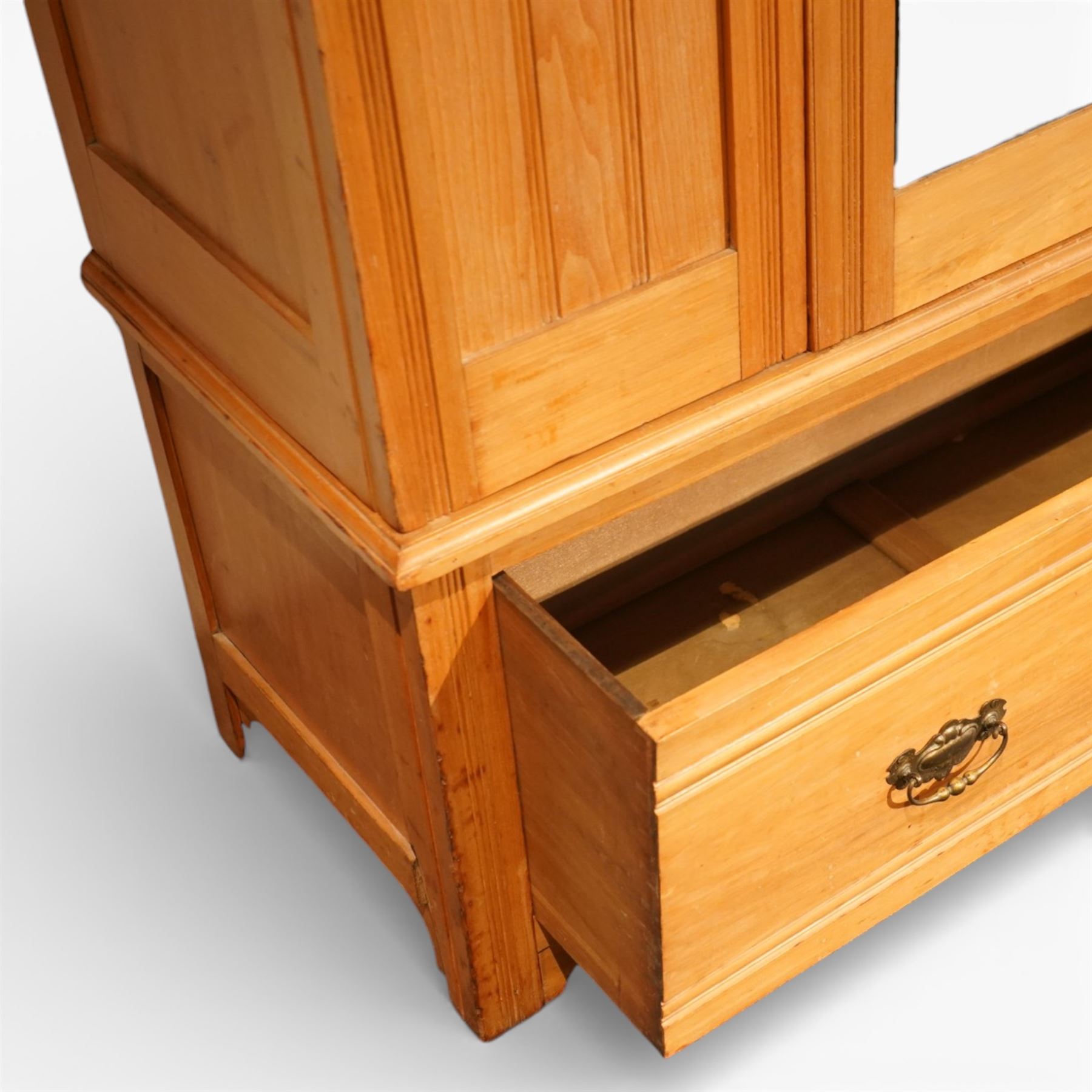 Edwardian ash single wardrobe, the moulded cornice above a single mirrored  hanging interior, flanked by panelled sections with drawer below, raised on bracket feet