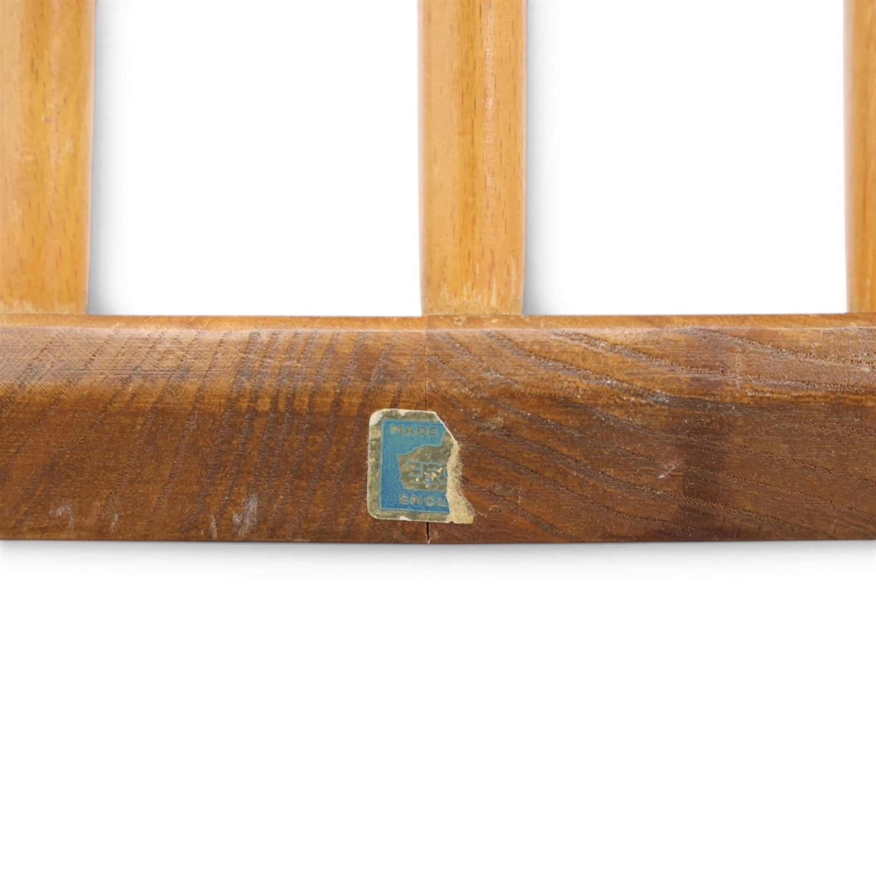 Ercol - 'Goldsmith' light elm set of four dining chairs, shaped cresting rail above seven spindles, dished seat raised on tapering supports with H-stretcher