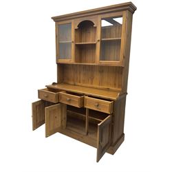 Polished traditional pine dresser, the raised back fitted with two display cabinets, the base fitted with three drawers and three cupboards