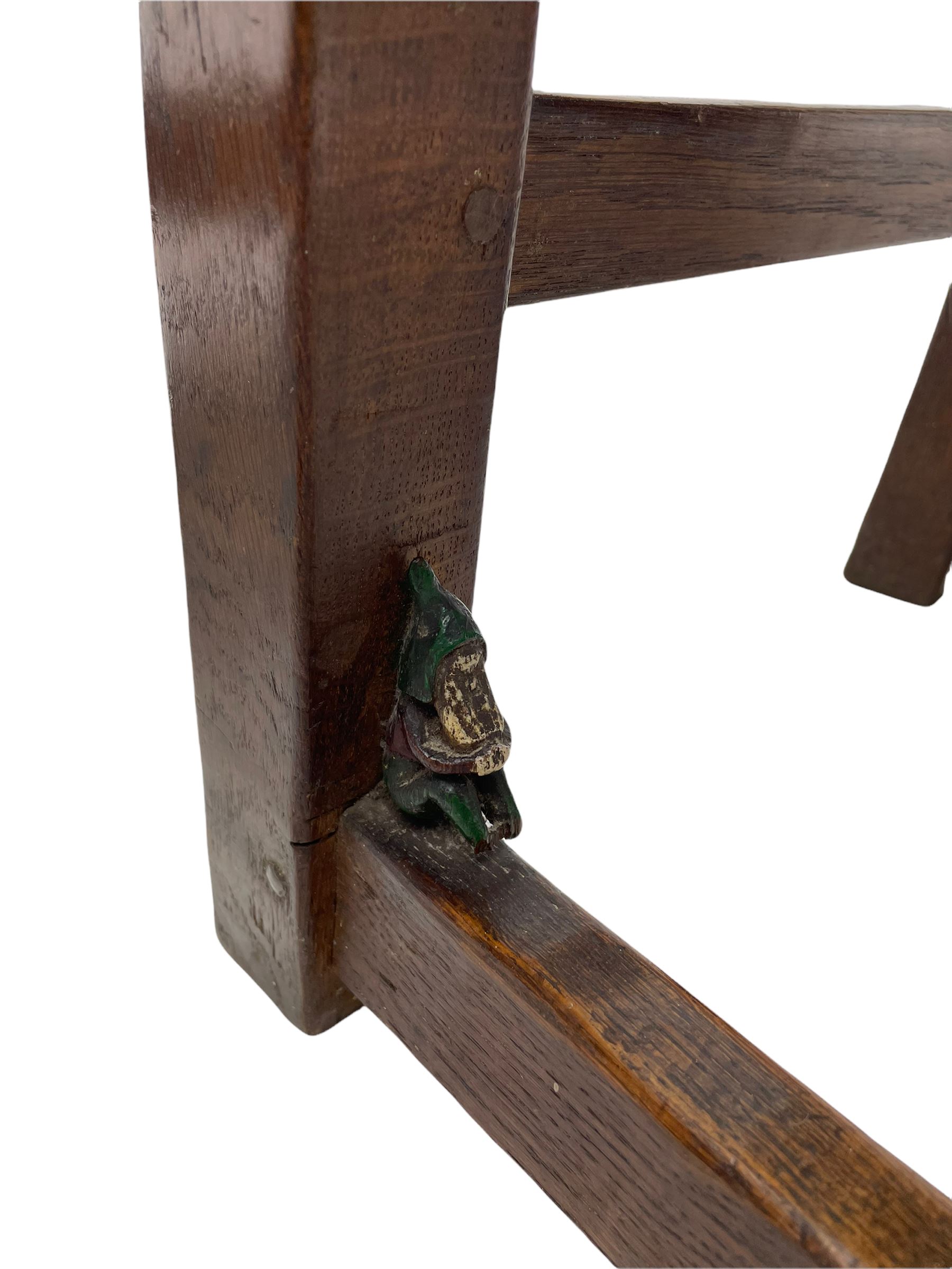 'Gnomeman' set of three oak dining chairs, panelled backs over curved seat rails with drop in rope rush seats, turned front supports with collar joined by plain stretchers, two with carved seated gnome figures, painted

Provenance - This collection of early 'Gnomeman' furniture comes to us directly from the Whittaker family. The pieces were made by the vendor's father Thomas Whittaker in the 1930/40s for his own use. During this time, he lived in York and made items for himself and friends. Whittaker adopted the gnome as a signature and trademark after his move to Littlebeck, Whitby.