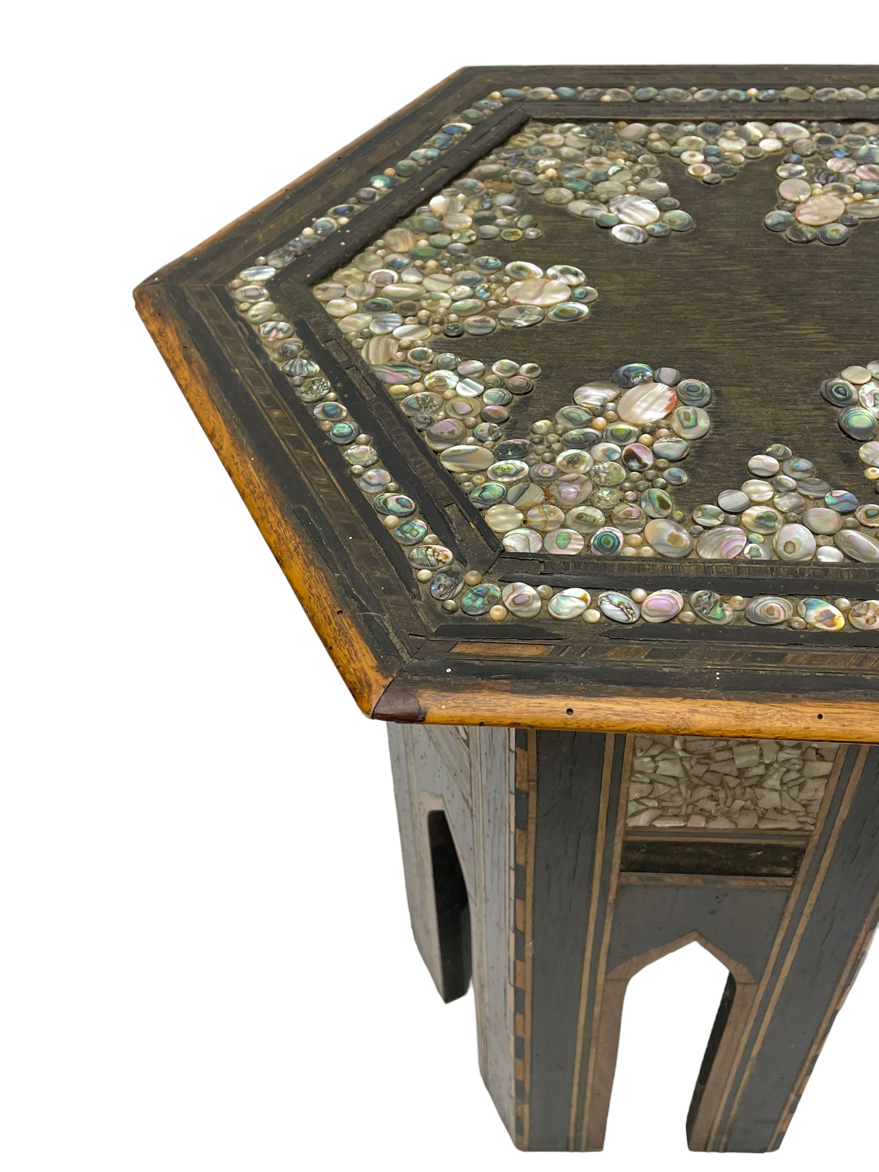 Early 20th century Anglo-Indian hexagonal table, the top decorated with mother of pearl beads and chequered banding, the base with fretwork pointed arches and inlays