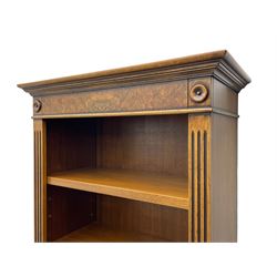 Georgian design walnut open bookcase, projecting cornice over figured banded frieze flanked by roundels, fitted with six adjustable shelves with flanking fluted uprights, on skirted base