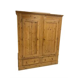 Large solid pine double wardrobe enclosed by two panelled doors over two drawers