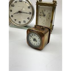Miniature 'Zenith' travel alarm clock, in engine turned brass case with silvered numerical chapter ring, H5cm, together with other clocks to include Aynsley Portland Ware mantel clock, with moulded peacock design, Europa travelling clock, brass carriage clock, German copper clock of cube form etc