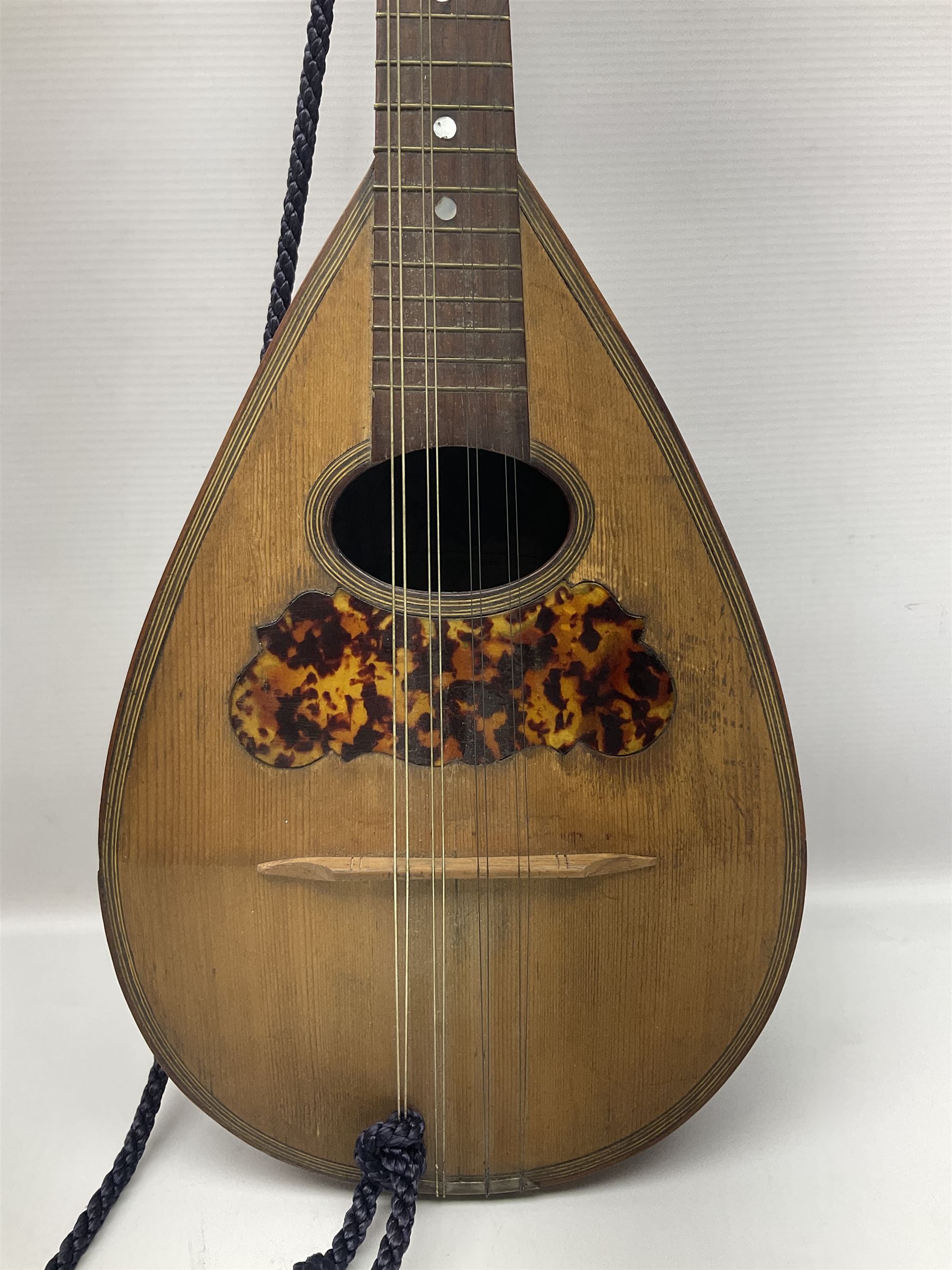 Late 19th/early 20th century Italian lute back mandolin with segmented back and spruce top; bears maker's label for Pietro Tonelli Napoli; together with a mandolin instruction booklet and a folding music stand L60.5cm