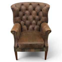 Pair of Georgian design wingback armchairs upholstered in brown leather and tartan tweed fabric, button back and scrolled arms with brass studded trim, square tapered supports