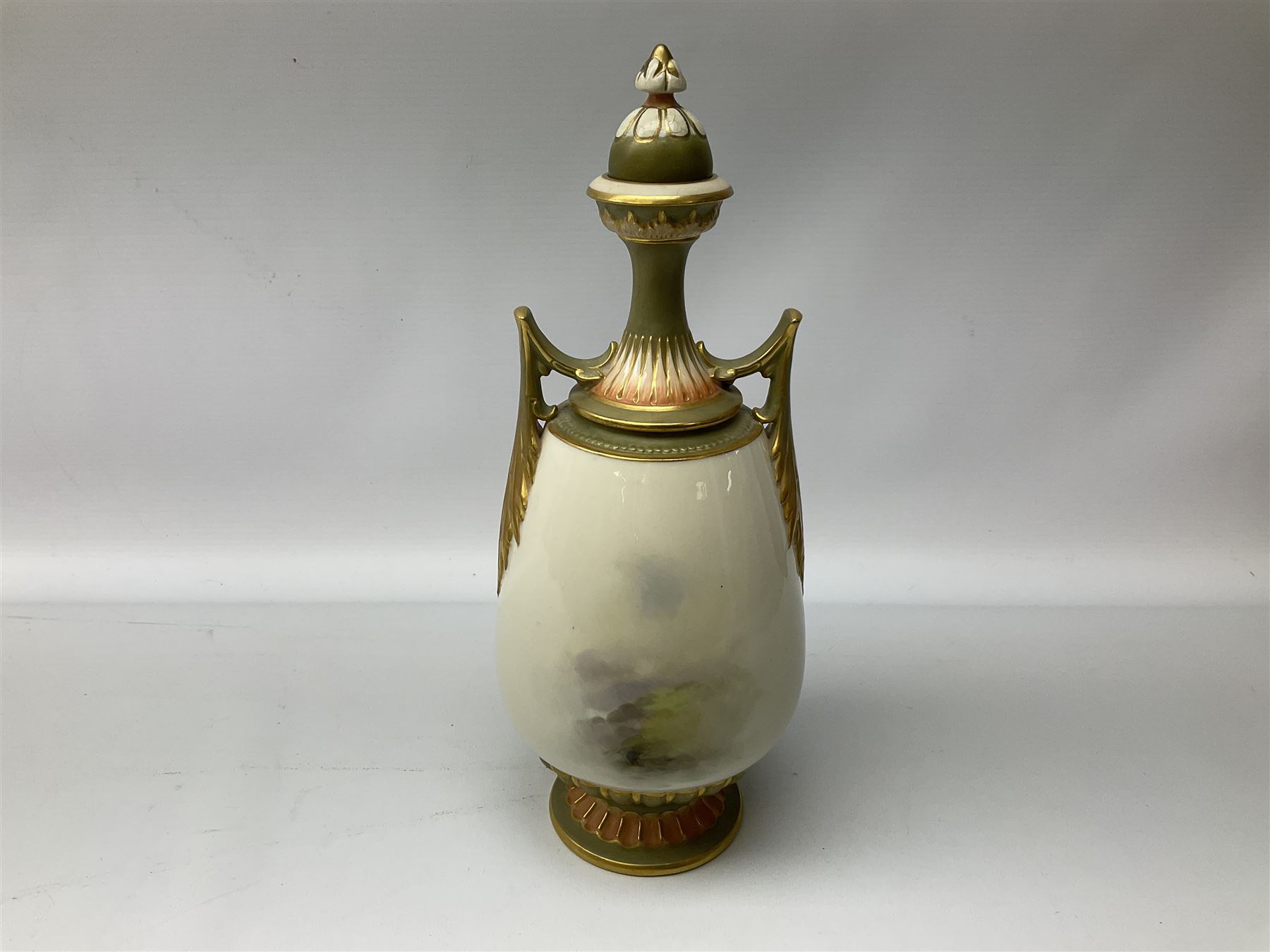 Early 20th century Royal Worcester vase decorated by Harry Davis, of ovoid form with twin acanthus mounted handles and waisted high neck supporting a domed cover, upon a circular foot, the body hand painted with sheep in a highland landscape, signed H Davis, with puce printed marks beneath including shape number 2425, and date code for 1907, H27.5cm