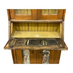 Late 19th century Aesthetic Movement period scumbled pine bureau bookcase, projecting cornice with fretwork frieze, enclosed by two glazed doors, panelled fall front over double cupboard, fretwork brass strap hinges 
