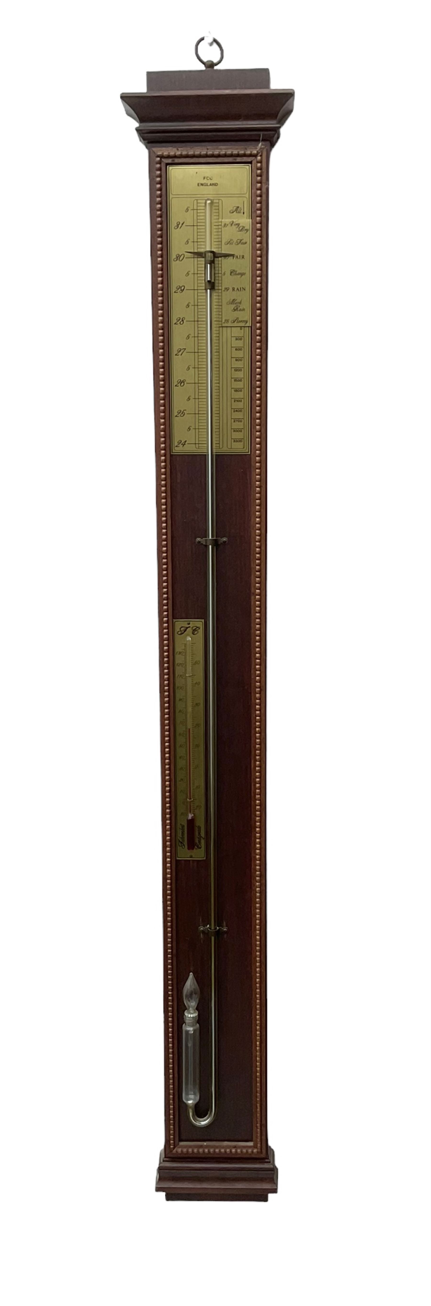 20th century - Replica mercury wall mounted stick barometer, fully glazed case with a gilt register measuring air pressure in inches, adjustable vernier and recording pointer, with a conforming thermometer  recording the temperature in degrees Fahrenheit and Celsius.  
