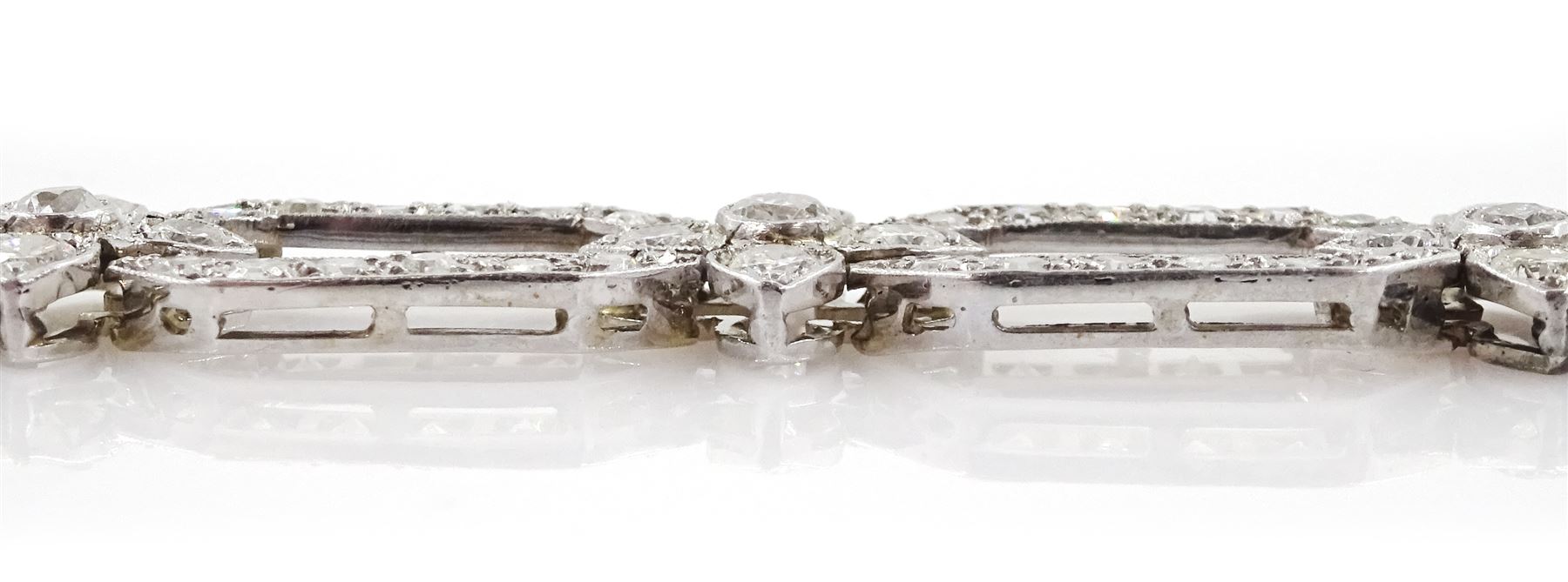 18ct white gold and platinum, milgrain set old cut diamond flower head and openwork panel link bracelet, total diamond weight approx 4.25 carat