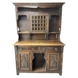 Late 19th century carved oak dresser, fitted with two drawers and two cupboards, raised upper piece with mottled coloured glass door