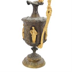 Pair of bronzed and gilt ewers in the Neo-Classical taste, each of typical form with figural detailed and mounted scroll handle surmounted by a winged figure, the bodies cast with scrolling strapwork, flower heads and acanthus leaves, and further detailed with applied gilt classical figures to oval recesses, upon a knopped stem and spreading circular foot with conforming cast detail, H28cm