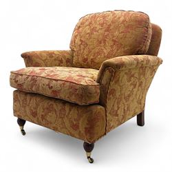 Duresta - Contemporary pair of upholstered armchairs, in red and gold damask style fabric, each with sprung seat and removable cushion back, rolled arms, on turned front supports with brass castors, square back legs 
