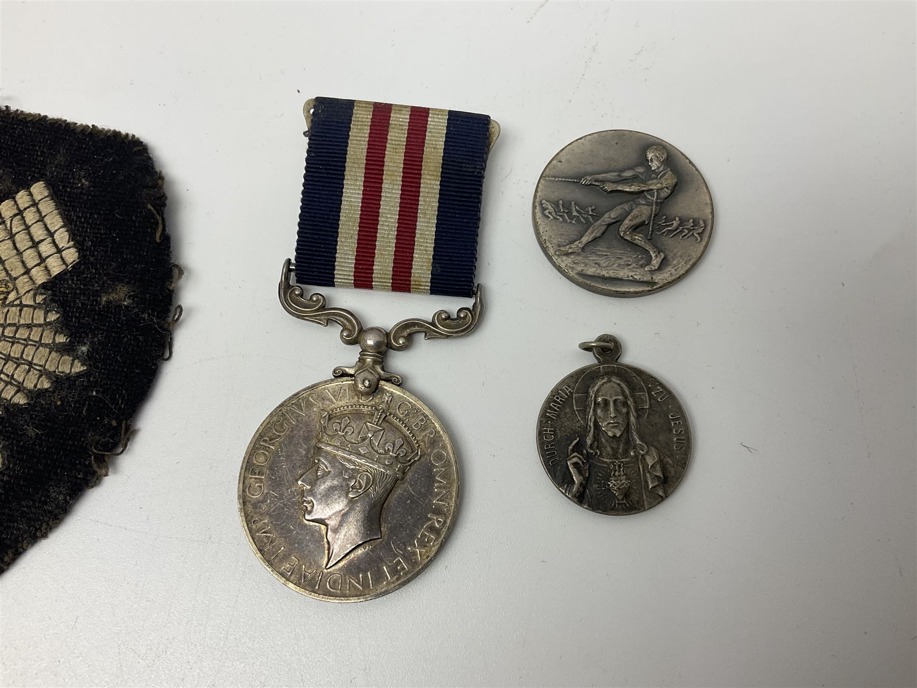WW2 Highland Light Infantry Military Medal group of five comprising MM, 1939-1945 War Medal, Defence Medal, 1939-1945 Star and France and Germany Star; three with ribbons; awarded to 1702538 A. Sjt. A.L. Alden H.L.I.; various copies of his citation giving details of his bravery on 26 Sep 44 at Donderdonk France when he single-handedly silenced an enemy machine gun nest. The citation also mentions a further heroic act on 15 Nov 44 when he risked his life to obtain vital information on the position of enemy mines and booby traps saving the lives of many other soldiers; the collection also comes with two contemporary group photographs of his Highland Light Infantry regiment, copy photograph of him being awarded the MM by Field-Marshall Montgomery, two post-war tug-o-war medallions and other items; together with a shooting medallion awarded to Gnr. J. Alden (his brother John) inscribed 123 L.A.A. Regt. R.A. Rifle Meeting Harburg 1945 and a Life Saving bronze medallion to J. Alden April 1938