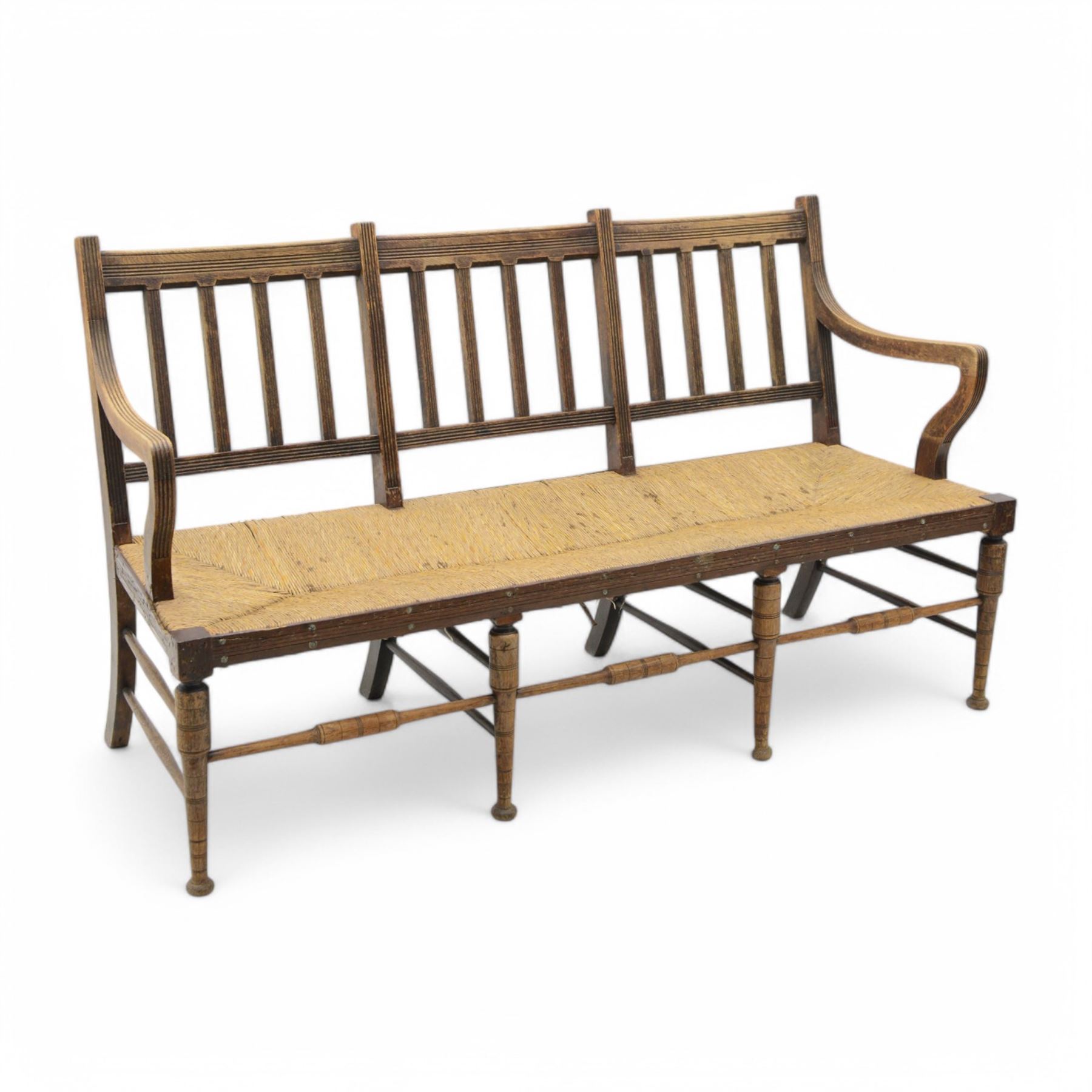 Liberty & Co. London - circa. 1890s ‘The Wykeham’ settle or bench, reeded frame and rush seat, on turned supports united by turned stretchers

The promotional sketch for ‘The Wykeham’ range can be seen in the ‘Liberty & Co. Handbook of Sketches, 1889’ p.49. It is also reproduced in Daryl Bennett’s ‘Liberty’s Furniture 1875-1915 […]’ p.106. Referred to as ‘The Wykenham: ‘oaken furniture’’. See images. 


