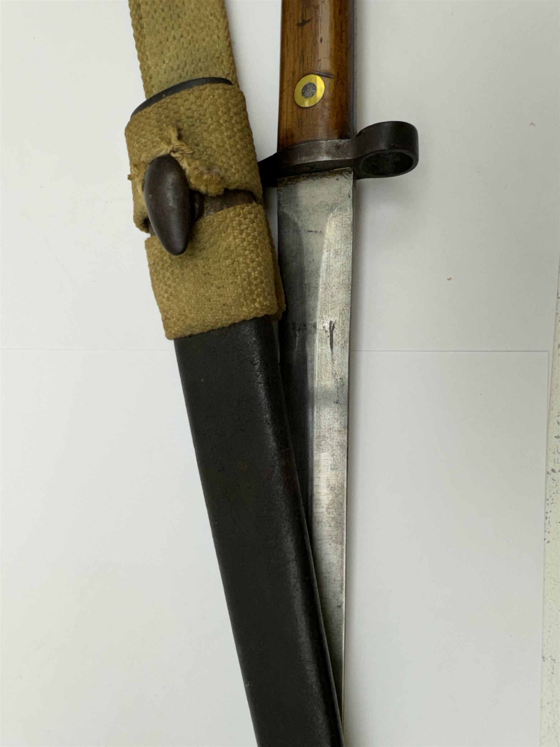 WWII Lee Metford rifle bayonet with original scabbard marked 586, with canvas frog, L44cm overall 
Notes; due to the condition of the bayonet it is possible this was issued to the home guard