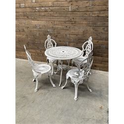 Victorian design cast alloy circular garden table and set of four chairs, ornate design in...