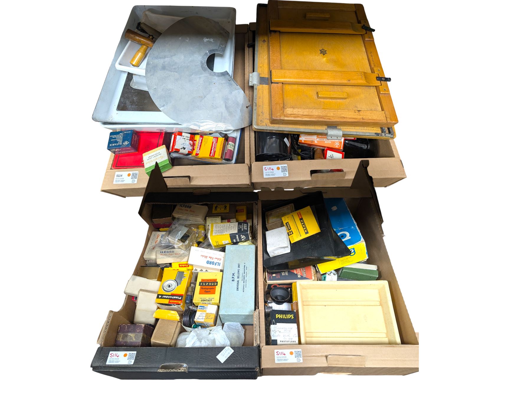 Collection of photography and photograph development accessories, including bulbs, development tanks, trays, projector lenses, etc