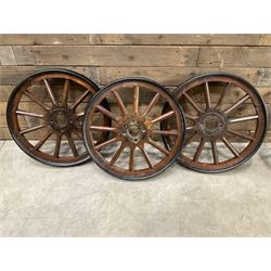 Set of four wheels from an early 20th century cart, wood with metal outer
