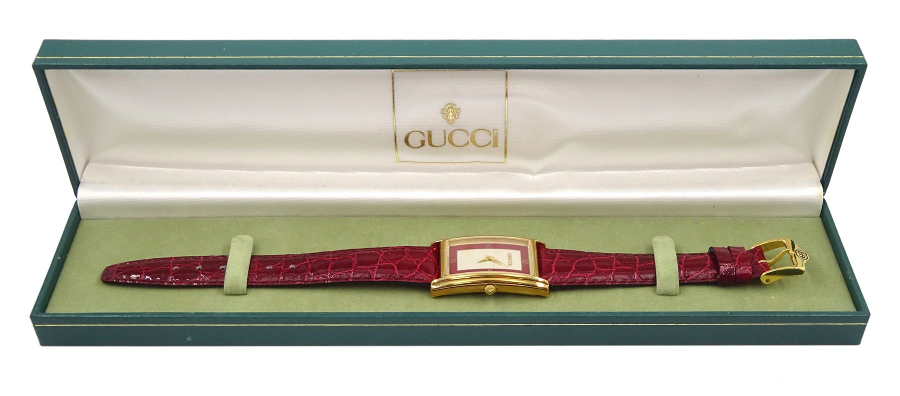 Gucci gold-plated rectangular quartz wristwatch, Ref. 2600M, red and silvered dial, on original red leather strap, boxed