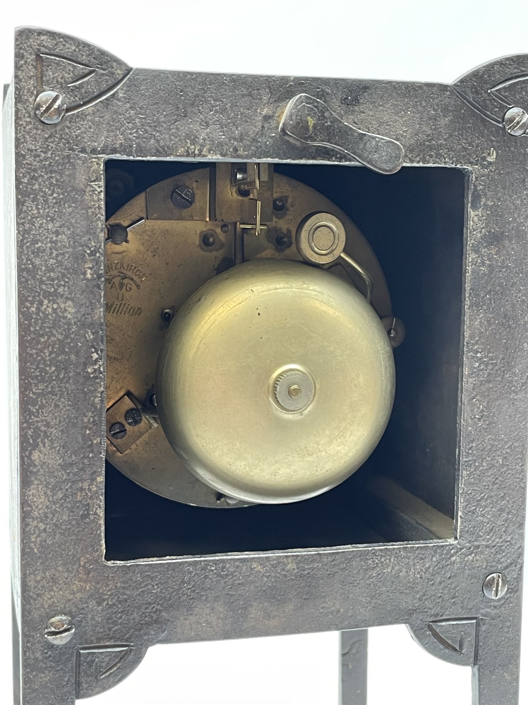 A German Arts and Crafts 'Gesamtkunstwerk' mantle clock c1890 in a square formed iron case with abalone incised triangles to each corner, case raised on four legs with inward facing feet,  convex copper chapter ring hand engraved with upright Arabic numerals, conforming copper hands in an individual style, with an eight-day spring driven rack striking movement manufactured by Lenzkirch, striking the hours and half hours on a bell, conforming steel pendulum with a hand-crafted faceted pear-shaped copper bob. With key.
Lenzkirch were one of the most prolific and respected German clock manufacturers of the 19th and early 20th century, it is highly probable that this movement was removed from another clock and incorporated into this artisan case when made at the end of the 19th century.